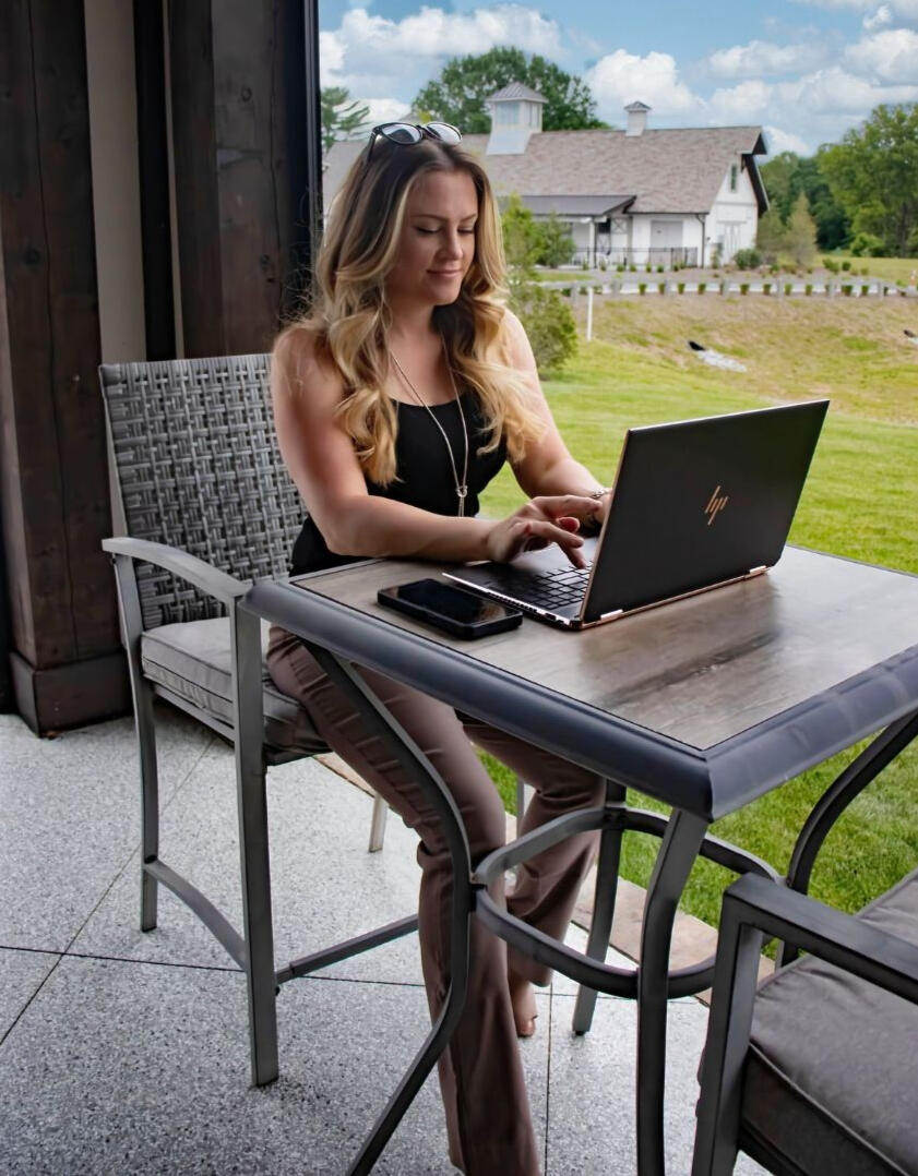 Let's get started A woman sitting at a table in front of a laptop